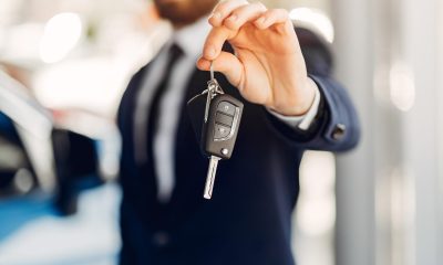 Man buying the car. Businessman in a car salon