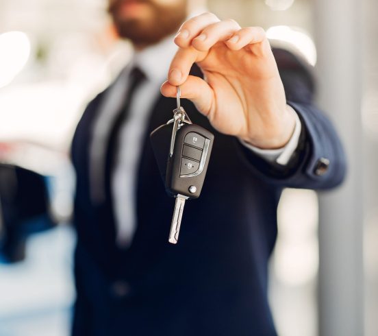 Man buying the car. Businessman in a car salon