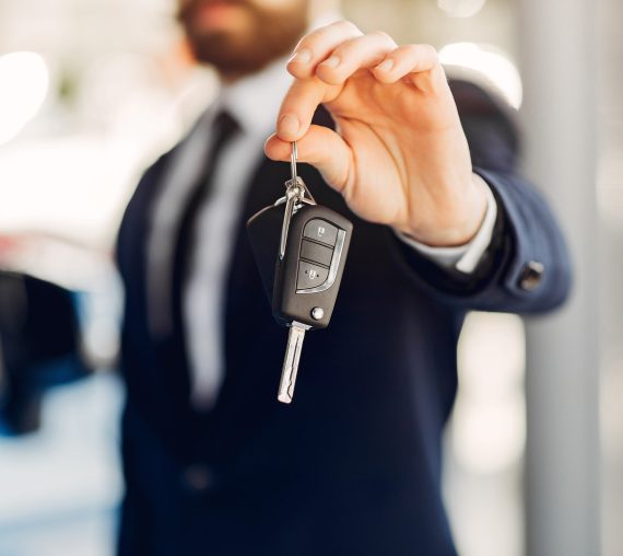 Man buying the car. Businessman in a car salon