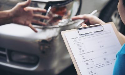 Insurance agent working during on site car accident claim process - people and car insurance claim concept
