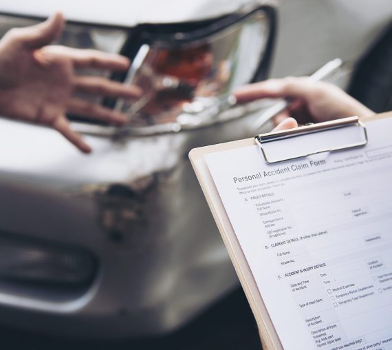 Insurance agent working during on site car accident claim process - people and car insurance claim concept